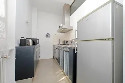 a kitchen with a refrigerator and a sink at 4BNB - Testaccio Apartment in Rome