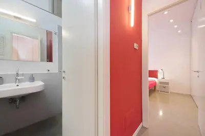 a white bathroom with a toilet and a sink at 4BNB - Testaccio Apartment in Rome