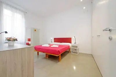 a white bathroom with a sink and a shower at 4BNB - Testaccio Apartment in Rome