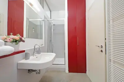 a large kitchen with a stove top oven in it at 4BNB - Testaccio Apartment in Rome
