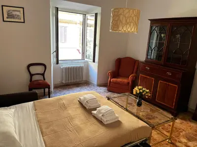 a bedroom with a bed and a table with towels on it at Be Your Home - Stendardi's House in Rome