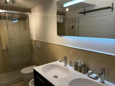 a bathroom with a sink and a toilet and a mirror at Be Your Home - Stendardi's House in Rome