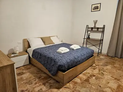 a bedroom with a bed with two towels on it at Be Your Home - Stendardi's House in Rome