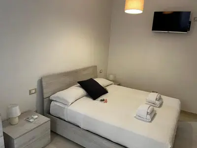 a bedroom with a bed with towels on it at Be Your Home - Stendardi's House in Rome