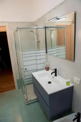 a bathroom with a sink and a shower at Locazioni Ostiense - Domus William in Rome