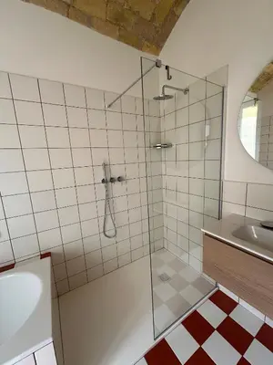 a bathroom with a glass shower and a sink at Santamaura Vatican Apartment in Rome