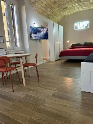 a room with a table and chairs and a bed at Santamaura Vatican Apartment in Rome