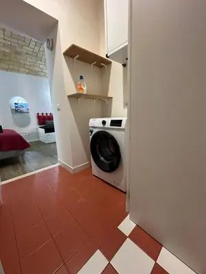 a kitchen with a washing machine in a room at Santamaura Vatican Apartment in Rome