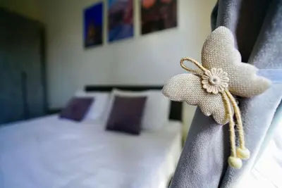 a hotel room with a bed with a flower on the seat at (9)Nine stops from the Colosseum in Rome
