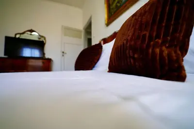 a close up of a bed with two pillows on it at (9)Nine stops from the Colosseum in Rome