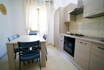 a kitchen with a counter and a table and chairs at (9)Nine stops from the Colosseum in Rome