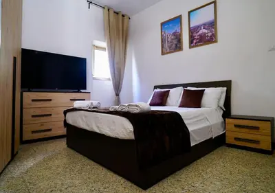 a bedroom with a bed and a flat screen tv at (9)Nine stops from the Colosseum in Rome