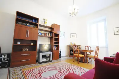 a living room with a table and a tv at Casa Anna a Roma in Rome