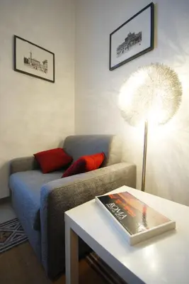 a living room with a couch and a table with a book at Casa Anna a Roma in Rome