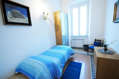 a bedroom with a bed and a desk and a window at Casa Anna a Roma in Rome