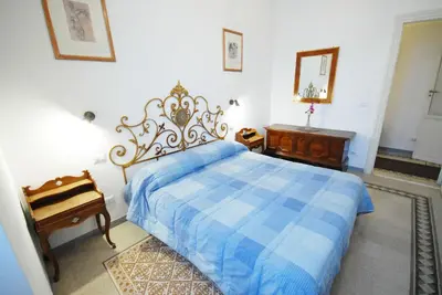 a bedroom with a blue bed and a mirror at Casa Anna a Roma in Rome