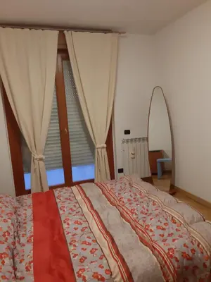 a bedroom with a bed with a canopy and a window at La casa di Gloria in Rome