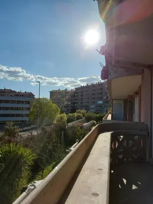 a balcony of a building with the sun in the sky at La casa di Gloria in Rome
