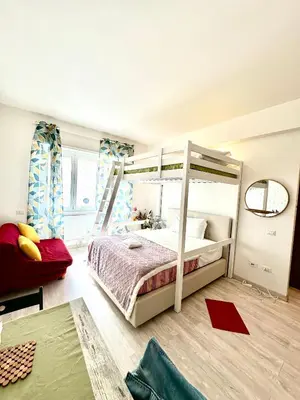 a bedroom with a bunk bed and a couch at Rome Apartment Marconi in Rome