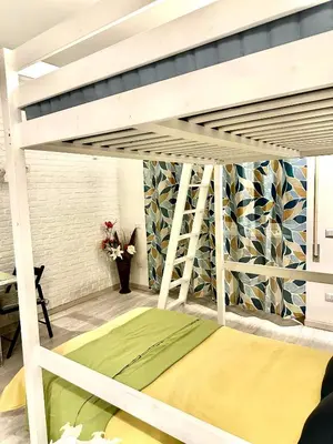 a loft bed with a green mattress in a room at Rome Apartment Marconi in Rome