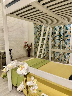 a room with a bed with flowers on the floor at Rome Apartment Marconi in Rome