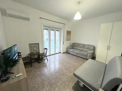 a living room with a couch and a television at Cuore di Marconi Apartment in Rome