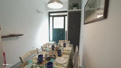 a dining room with a table and a green door at Belle Arti home in Rome