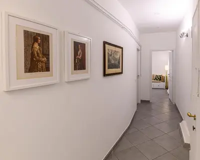 a hallway with three framed pictures on a wall at Belle Arti home in Rome
