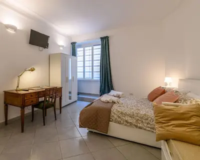 a bedroom with a bed and a desk and a deskablish at Belle Arti home in Rome