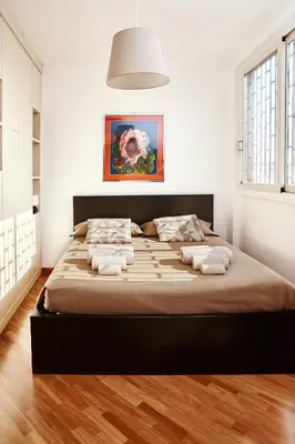a bedroom with a large bed in a room at Monteverde Suite Apartment in Rome