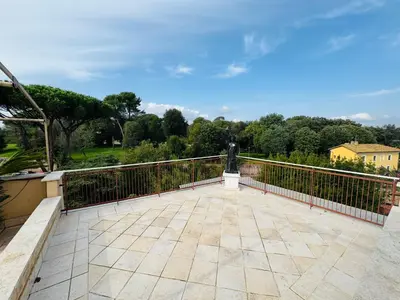 a balcony with a fence and a statue on it at Monteverde Suite Apartment in Rome