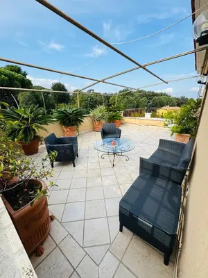 a patio with chairs and a table on a balcony at Monteverde Suite Apartment in Rome