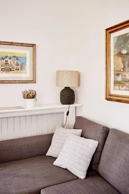 a living room with a couch and a lamp at Monteverde Suite Apartment in Rome