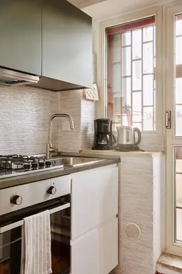 a kitchen with a sink and a stove top oven at Monteverde Suite Apartment in Rome