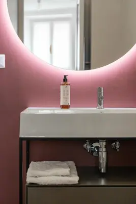 a bathroom with a sink and a mirror at Mecenate Suite Colosseum in Rome