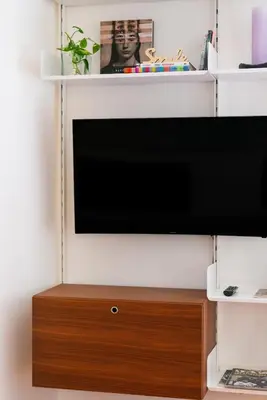 a flat screen tv on a white wall at Mecenate Suite Colosseum in Rome