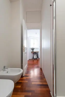a bathroom with a white tub and a sink at Mecenate Suite Colosseum in Rome