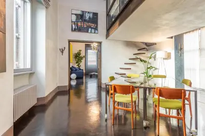 a dining room with a table and chairs at Iconic apartment with unique Colosseum view in Rome