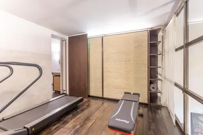 a gym with a treadmill and a window at Iconic apartment with unique Colosseum view in Rome