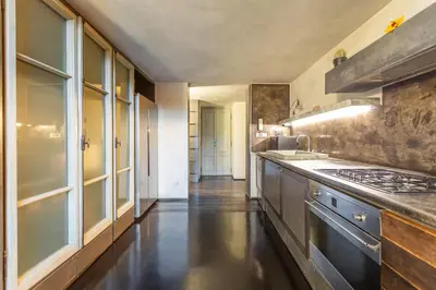 a kitchen with a sink and a stove at Iconic apartment with unique Colosseum view in Rome
