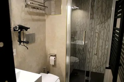a bathroom with a shower and a toilet at Joyful 148 Luxury Guest House in Rome