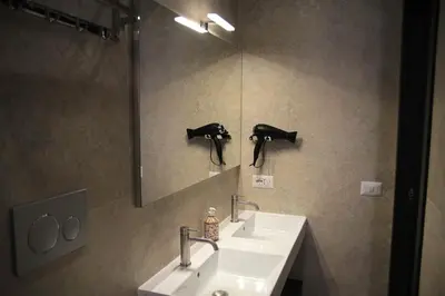 a bathroom with a sink and a mirror at Joyful 148 Luxury Guest House in Rome