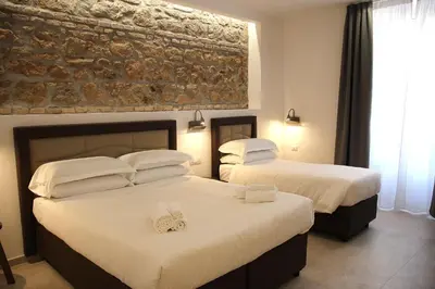 two beds in a hotel room with towels on them at Joyful 148 Luxury Guest House in Rome