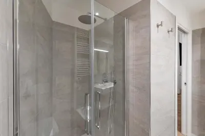 a shower with a glass door in a bathroom at ELICAL Vatican Suites in Rome
