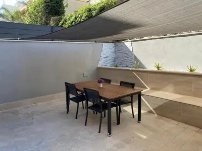a wooden table and chairs on a patio at Domus Carola in Rome