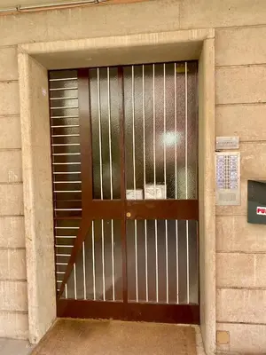 a door with a metal gate in a building at Domus Carola in Rome