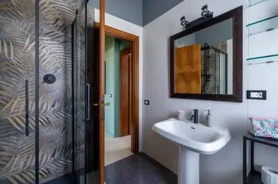 a bathroom with a sink and a shower with a mirror at Spacious with terrace 3 bedroom, metroA Battistini in Rome