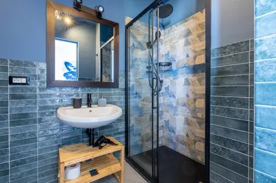 a bathroom with a sink and a shower at Spacious with terrace 3 bedroom, metroA Battistini in Rome