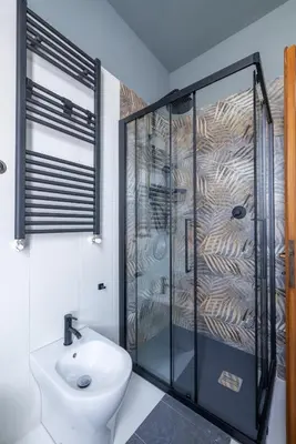 a bathroom with a shower and a toilet and a sink at Spacious with terrace 3 bedroom, metroA Battistini in Rome