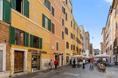 a bedroom with a bed and a table and chairs at Vatican Borgo Gem Stay in Rome